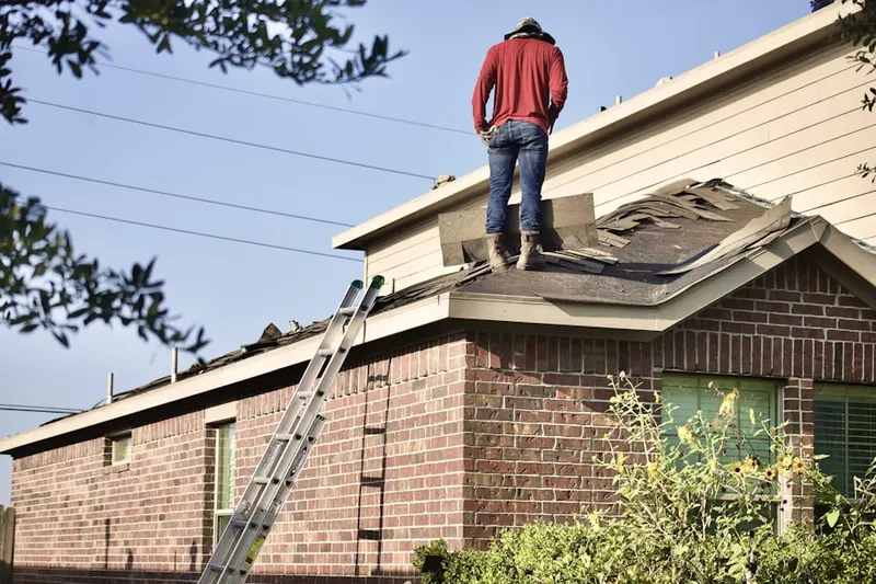 Professional roofer working on a residential roof in Bellasera
